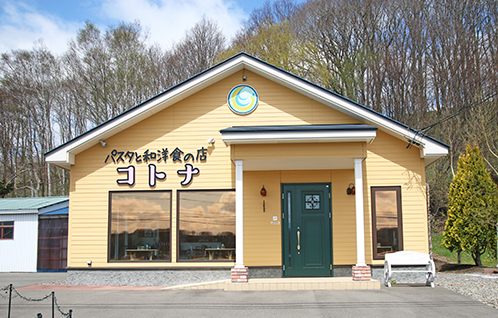 黄色を基調とした外壁にパスタと和洋食の店コトナと書かれた建物の写真